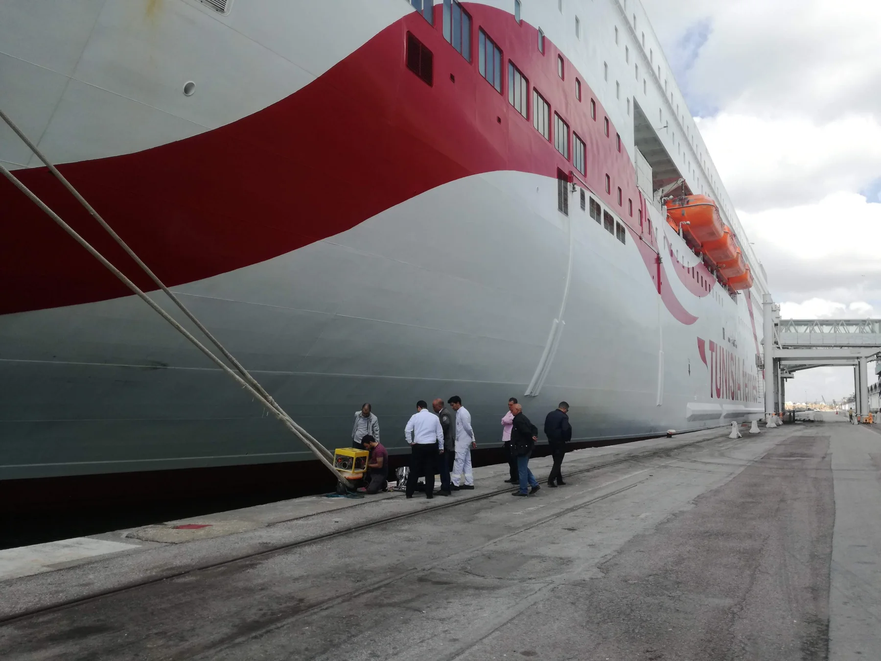The yellow ROV on the quay beside a large ferry